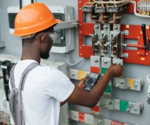 electrician-checking-voltage-in-switchgear-at-solar-station.jpg